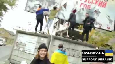 People tear the poster with the inscription 
