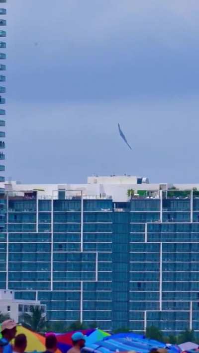 B-2 Spirit stealth strategic bomber flying over Miami beach.