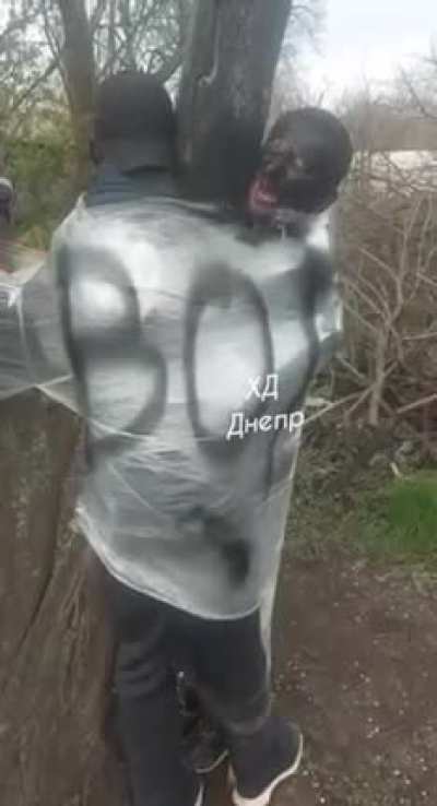 Tied to a tree and black faced to mark them a thief in Ukraine