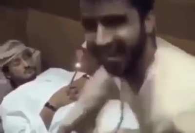 man put a rocket between his friend's hand while he was asleep