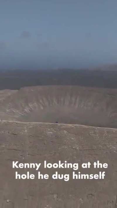Kenny looking at the hole he dug himself