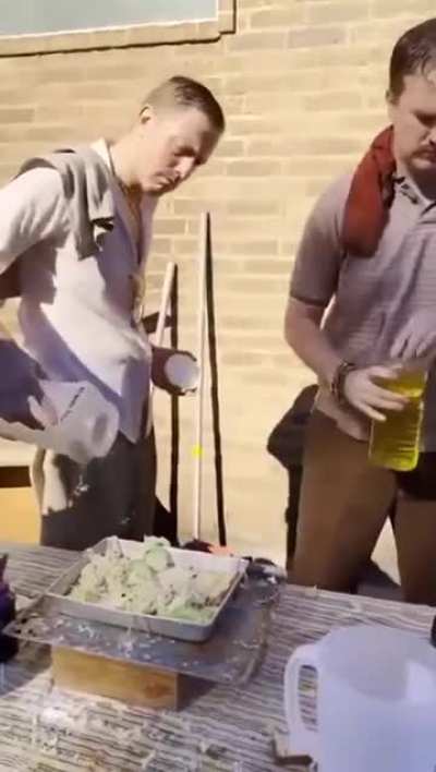 White guys imitating Indians making street food.