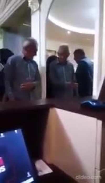 Two symmetrical drunk men not letting each other pass
