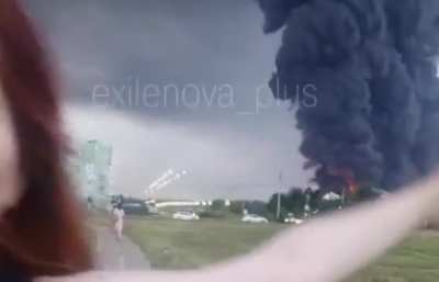 Young Russian woman celebrates in front of a Wildberries logistics facility today after it have hit by Ukrainian drones