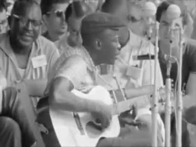 John Lee Hooker is performing “Boom Boom” at the Newport Folk Festival in 1963