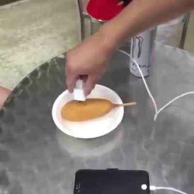 Charging up a phone with monster and a corn dog