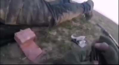 Isis militant using dying friend as cover while reloading, Syria, 2014.
