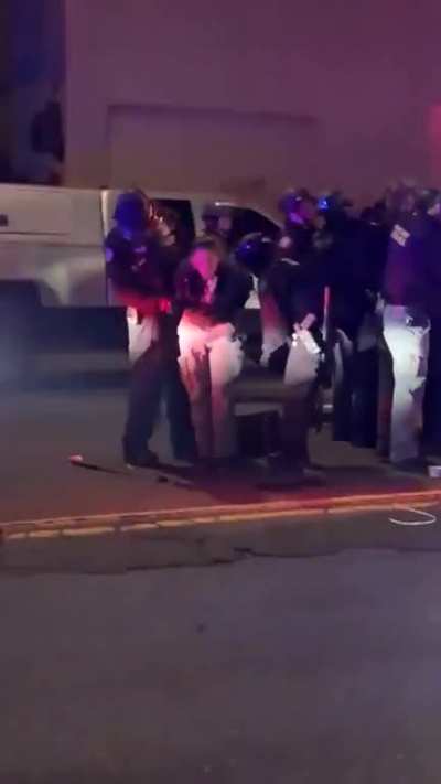 Portland police removing journalist's press badge and stealing her cash from her pockets as she vomits from tear gas exposure. Portland police arrested her for walking across the street.
