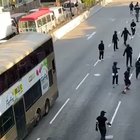 Police officer attempts to dispel protesters by driving at them with motorcycle