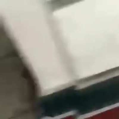 LA rioter lights firework on street. Gets it thrown back into his car.