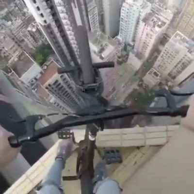 Man Rides his Bike on edge of a SKYSCRAPER and almost fell off