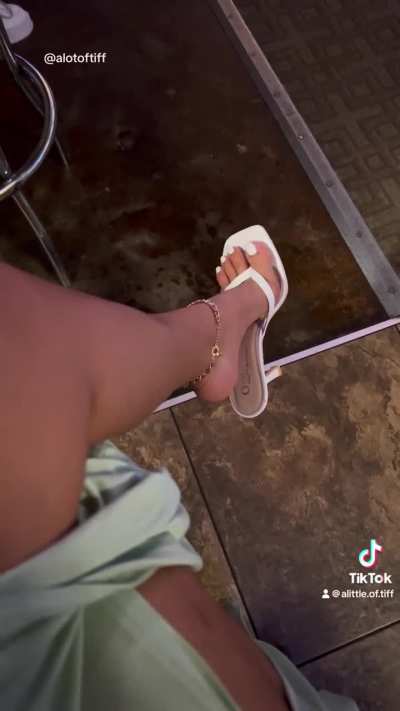 High heels dangling in a bar
