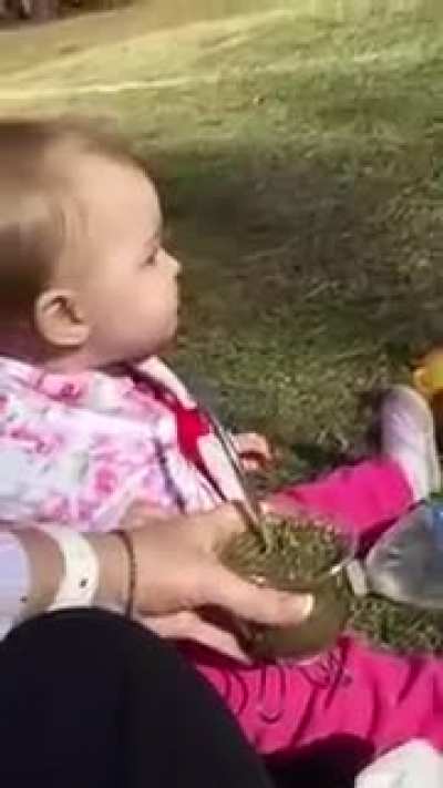 Baby tasting herbal tea for first time