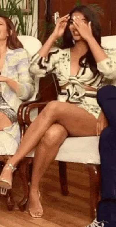 Indian actress Pooja Hegde showing her sexy legs and thighs - sitting cross-legged in short dress.