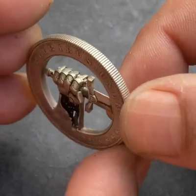 A modified US 1 Dollar Coin with a Hidden Button for Clasping and Unclasping a Sword