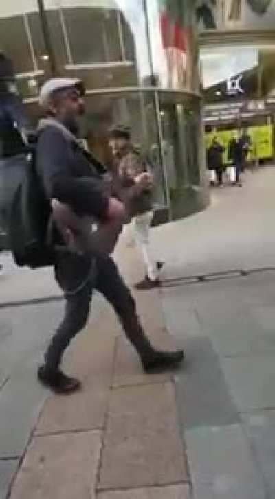 A busker performs The Auld Triangle through Dublin city