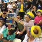 He passed out at the game so people joined together to stack cups on his head