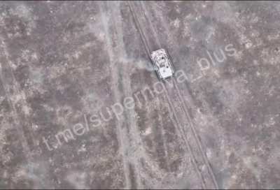A Ukrainian drone drops a munition on a moving Russian BMP filled with infantry resulting in them jumping off the vehicle, somewhere near Marinka