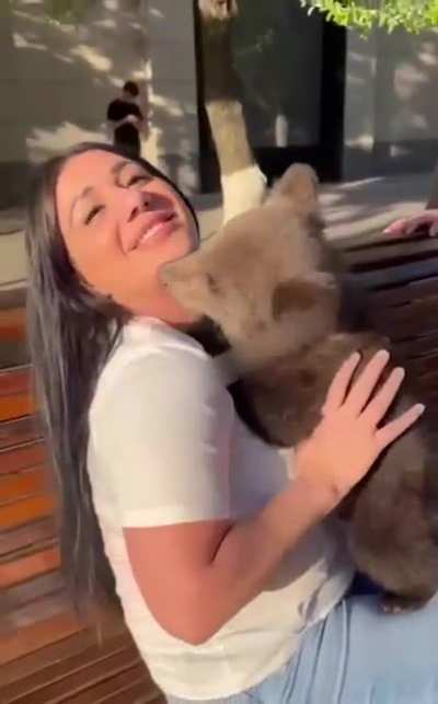 Hugging a bear cub