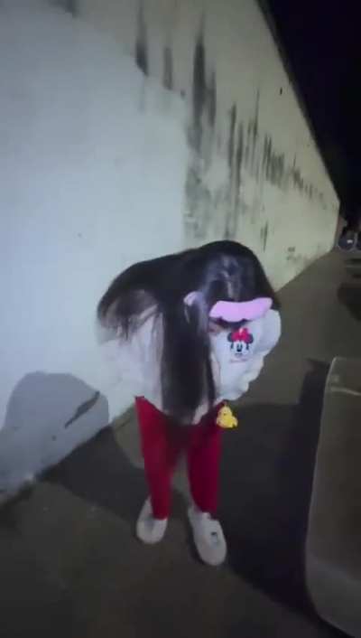 In the middle of the street... in the middle of the night... promoting her outfit 😳