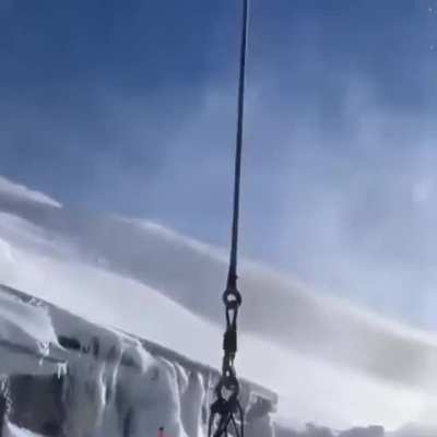 Helicopter picking up a month's worth of garbage from a hidden bunker in the mountains
