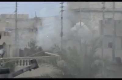 Bradley IFV using it's Bushmaster and TOW missile against insurgent-held building in Fallujah.