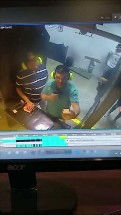 guy points gun at buddies head for a picture