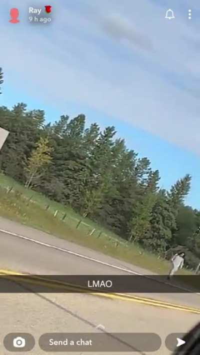 Holding a rifle and looking the other way while officers surround you. Wetaskiwin, Alberta.