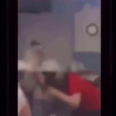 two girls jump a teacher