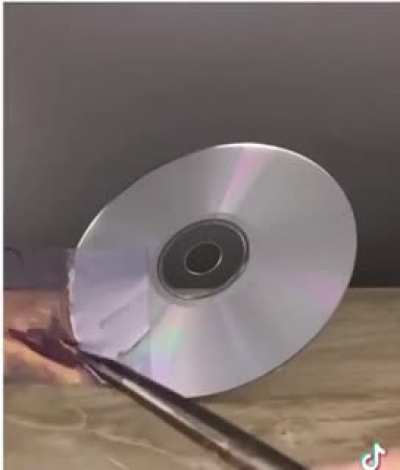 Painter matches the color of a CD with paint