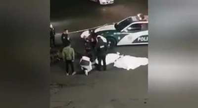 Some kids run a red light on a motorscooter.