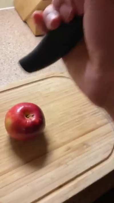 Opening an apple with a knife