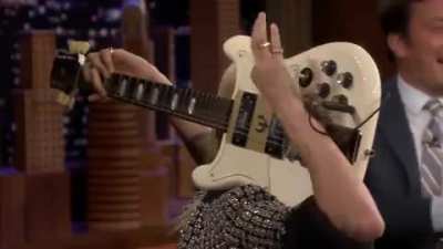 Cara Delevingne Plays Sweet Home Alabama On A Guitar Behind Her Head.