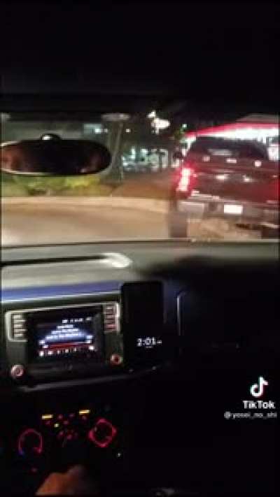 Lifted truck tries driving over a curb on their way out of the drive through and gets stuck.