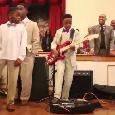 A father's humorous reaction as he proudly watches his son perform