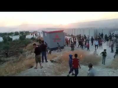 Hatay'ın Rehyanlı ilçesinin karşısında bulunan Atme sınır kampındaki yüzlerce Suriyeli mülteci, beton duvarı aşarak Türk askerinin nöbet tuttuğu kulübeyi bir süreliğine ele geçirdi. Tarlalarını ateşe veren Suriyeliler, köylüler yangınları söndürmeye çalış