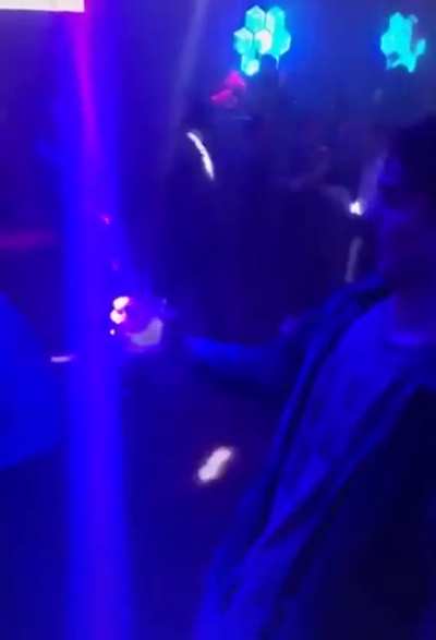 This guy perfectly times a light in his cup at a club and I can't stop watching