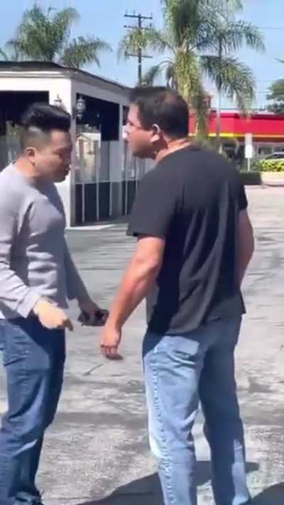 Passenger confronts man who called driver a racial slur during parking lot incident