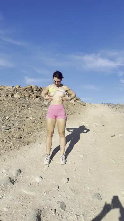 Topless hike in the rocky hills under the sun
