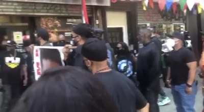Group of protesters in NYC target businesses that choose to stay open on Malcolm X birthday. They pressure an Asian American man to close his business