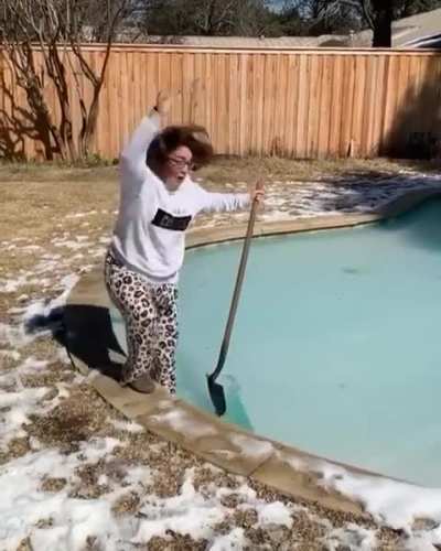 Woman tries to walk on a frozen pool