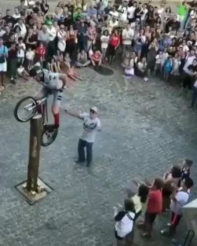 Riding a bicycle on a tree stump...