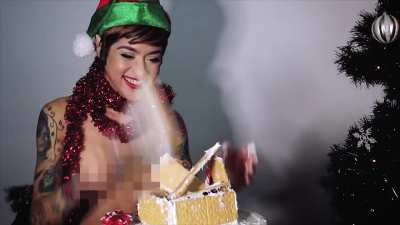 Johannie decorating a gingerbread house while riding a Motorbunny. It's not just the cake that's getting creamed