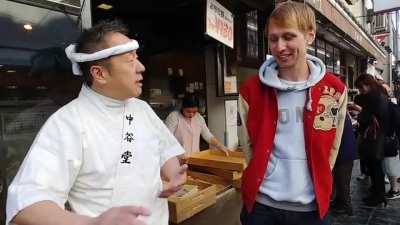 Bucket drummer drums to the beat of mochi making masters of Nara.