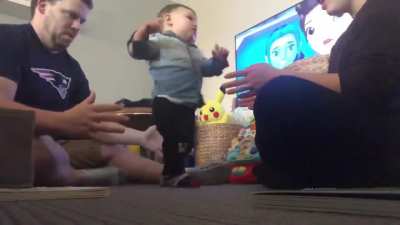 A fathers reaction to seeing his 11 month old take their first steps.