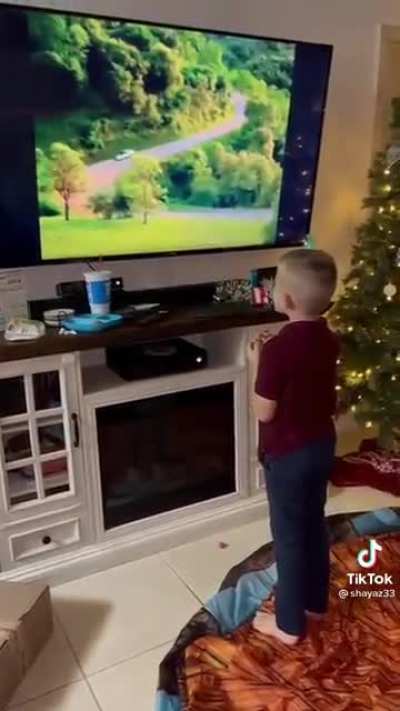 Parents showing their kiddo an old car commercial