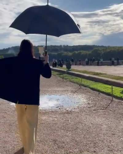 Twirling around with her umbrella