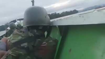 Myanmar/Burmese People's Defense Force attacking Junta troops that are on an island in the Ayeyarwaddy river.