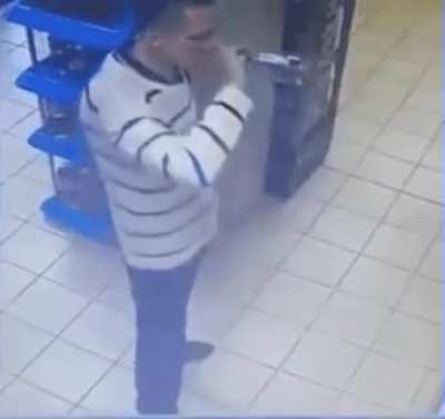 Russian man casually drinking an entire bottle of vodka to avoid paying for it