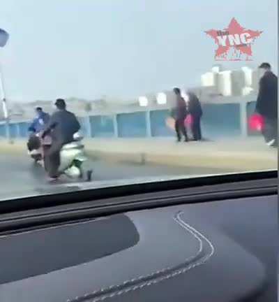 Chinese man drags wife at the back of scooter after having argument. WTF